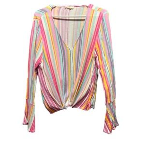 Long sleeve top with ruffle sleeves. Ties at the bottom.